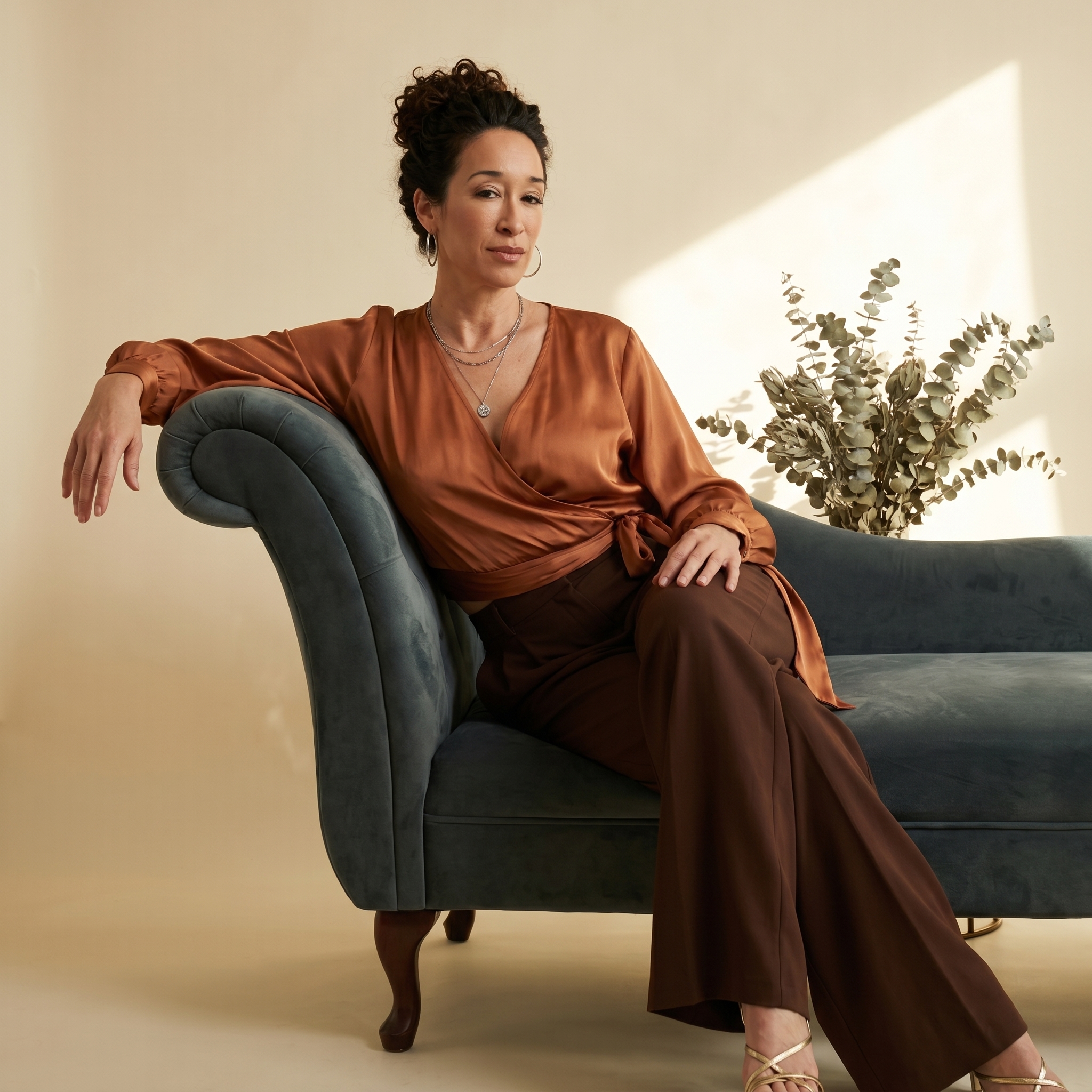 Cassandra Quick seated on velvet chaise